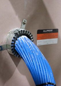 Data Cable Bundle fire collar low profile plasterboard wall with data cables install