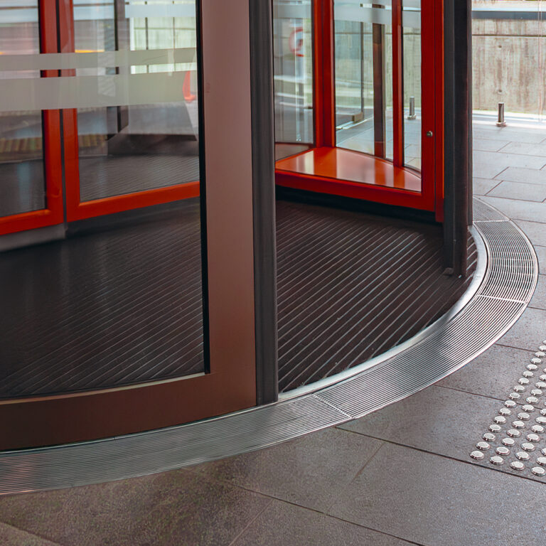 Horizon Hotel curved drainage system at revolving doors for level entry access